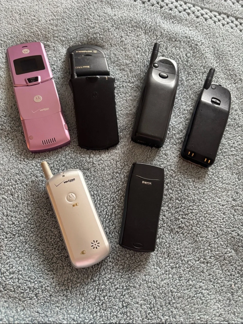 Vintage Collection of cell phones includes StarTAC and Pink Flip